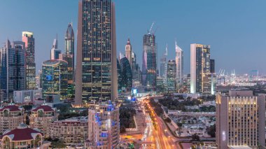 Şeyh Zayed Yolu 'nun Skyline manzarası ve Dubai, BAE' deki gece gündüz geçiş zamanı. Finansal merkezdeki aydınlık gökdelenler şehir merkezinin yukarısından gökyüzü manzarası