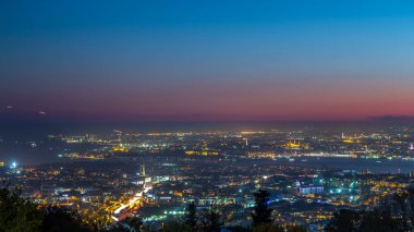 Istanbul night skyline scenery day to night transition timelapse, aerial view over Bosporus channel from Camlica hill. Blue water of Bosporus channel with ship. Traffic on roads