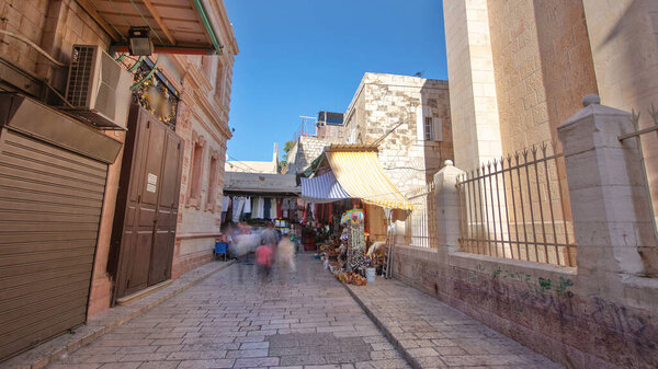 The colorful souk near Holy Sepulchre in the old city of Jerusalem Israel timelapse hyperlapse. Crowd of people passing by on this market