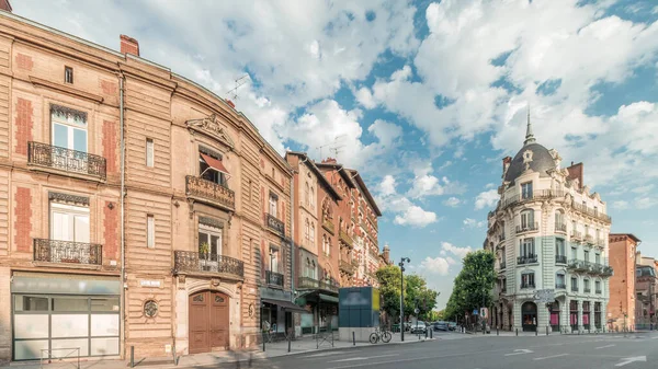 Panorama, Fransa 'nın Toulouse kentindeki Rue du Languedoc ve Theodore Ozenne kavşağında tarihi tuğla cephelerini gösteriyor. Canlı şehir merkezindeki Carmes metro istasyonu yakınlarındaki dükkanlar, kafeler, yol trafiği