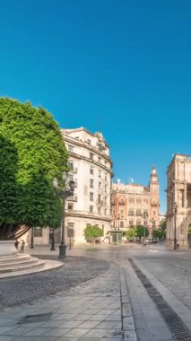Panorama, Sevilla, San Francisco Plaza 'daki belediye binasının sabah saatlerini gösteriyor. Mavi gökyüzü altında geleneksel Endülüs binalarıyla çevrili Kasa Düşünceli, Plateresk mimari