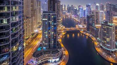 Dubai, Birleşik Arap Emirlikleri güneş battıktan sonra gece geçiş timelapse tüm Dubai Yat Limanı mesire ve kanal kayan yat ve tekne ile günler güzel hava üstten görünüm. Modern kuleleri ve yolda trafik.