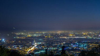 Istanbul night skyline scenery day to night transition timelapse, aerial view over Bosporus channel from Camlica hill. Blue water of Bosporus channel with ship. Traffic on roads