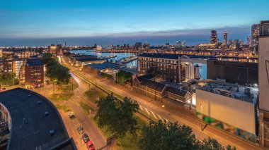 Rotterdam 'daki Katendrecht ve Maas Nehri gibi demirli gemilerle Maashaven' daki hava panoramik görüntüsü günden geceye geçiş zamanı. Eski fabrika yakınlarındaki trafik ofis ve etkinlik alanına dönüştü