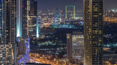 Dubai şehir merkezinden geceye geçiş zamanı, aydınlatılmış lüks modern binalar, Birleşik Arap Emirlikleri 'nin fütüristik şehir manzarası. Günbatımından sonra gökdelenden Elizabeth bölgesinin havadan görünüşü