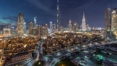 Dubai şehir merkezi silueti Burj Halife ve diğer panoramik manzaralı Dubai, Birleşik Arap Emirlikleri. Geleneksel ve modern binalar. Çevre yolunda trafik ve gün batımından sonra çeşmeler