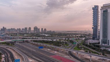 Dubai Marina ve Jlt gökdelenleri yakınlarındaki Şeyh Zayed yoluna giden hava manzaralı sabah saatleri, Dubai. Trafik, köprüler ve metro hattı. Gün batımından sonra bulutlu gökyüzü. Birleşik Arap Emirlikleri