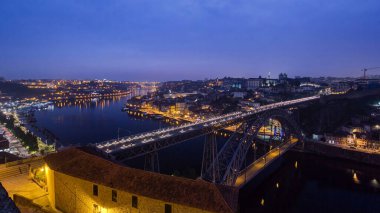 Day to night transition aerial panoramic view of the historic city of Porto, Portugal timelapse with the Dom Luiz bridge. Colorful sky after sunset