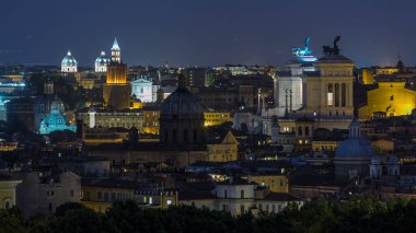 Roma, İtalya 'nın tarihi merkez gününden geceye geçiş zamanının panoramik hava görüntüsü. Vittoriano binasıyla gün batımından sonra şehir manzarası