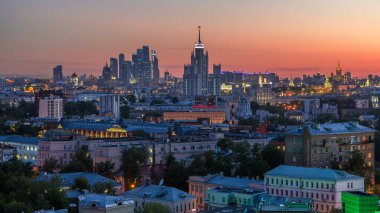 Gökdelenler geceden geceye geçiş zamanları çatıdan, Kremlin kulelerinden ve kiliselerinden, Moskova, Rusya 'da akşam havası panoramalarında Stalin evleri. Günbatımı turuncu gökyüzü