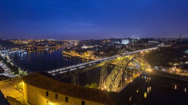 Day to night transition aerial panoramic view of the historic city of Porto, Portugal timelapse with the Dom Luiz bridge. Colorful sky after sunset