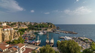 Aerial view of yacht harbor and red house roofs in Old town. Marine bay at touristic city center of Antalya. Sunny day in Antalya, Turkey landmark. Travel Antalya, Yachts of Antalya