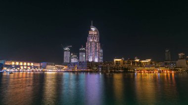 Dubai 'nin Dans Çeşmesi ve Göl' den Geceye Zaman Kaynağı, seçilen müziğin ritmine Dubai, BAE 'de eşlik eder. Çeşme alışveriş merkezi ve oteller tarafından gözden kaçırılmış.