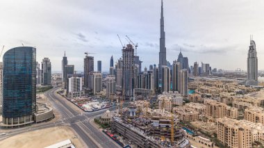 Dubai şehir merkezindeki güzel lüks panoramik manzaralı zaman çizelgesi, Dubai, Birleşik Arap Emirlikleri. Gökyüzünde kara bulutlar olan iş hangarı kulelerinden çatı manzarası. Yolda trafik vardı.