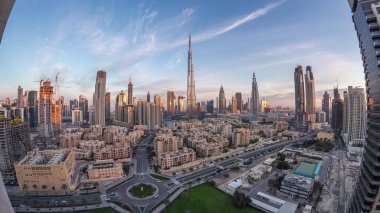 Dubai Şehir Merkezi 'nin ufuk çizgisi gece gündüz Burj Halife ve Dubai' deki diğer panoramik kulelerle birleşik Arap Emirlikleri. Daire yolunda trafik var. Geleneksel ve modern binalar.