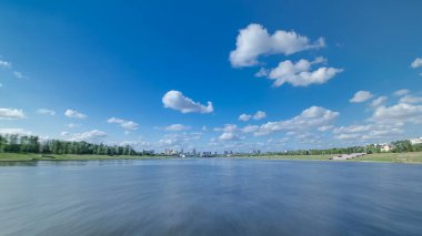 Astana, Kazakistan. Keyif teknesinden Astana 'da Ishim nehrinde hareketli bir seyahat görüntüsü. Mavi gökyüzü ve bulutlarla dolu bir yaz gününde. Bulanık hareket