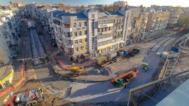 Beton, yol onarım şantiyesinde çok sayıda işçi ve mikser zaman ayarlı çalışıyor. Tramvay raylarının yeniden inşası. Tüm gün boyunca hava üst görünümü