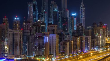Dubai Yat Limanı timelapse tüm gece boyunca muhteşem çatı manzarası. Işıklandırılmış gökdelenler, Birleşik Arap Emirlikleri, dönüm büyük bir şehir. Hava Jlt görünümünden