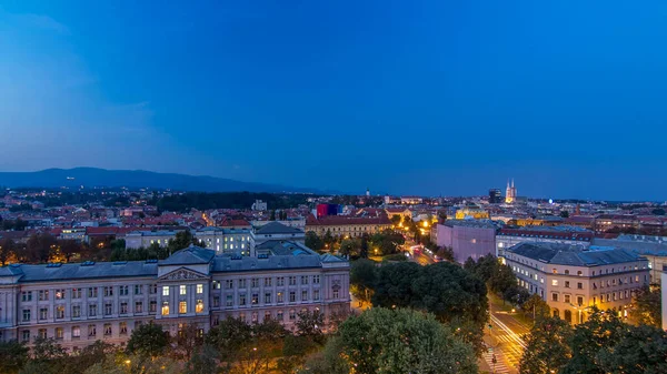 Panorama of the city center day to night transition timelapse shoot from top of the skyscraper with aerial view to intersection in front of national theater and museum in Zagreb, Croatia after sunset
