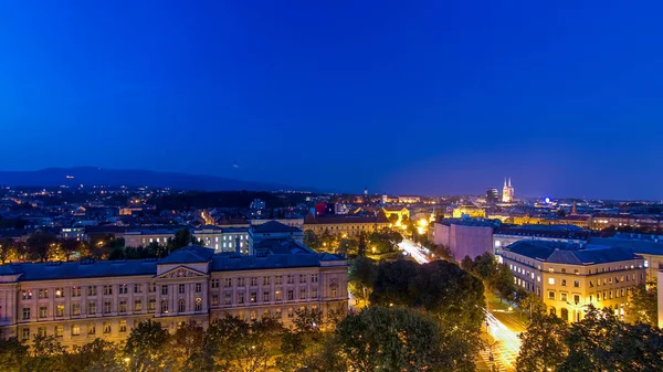 Panorama of the city center day to night transition timelapse shoot from top of the skyscraper with aerial view to intersection in front of national theater and museum in Zagreb, Croatia after sunset