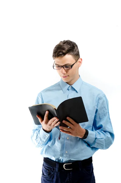 Teenager read and study from black book with eyeglasses isolated — Stock Photo, Image