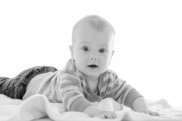 Enfant bébé garçon souriant sur une couverture blanche isolée sur bac blanc — Photo