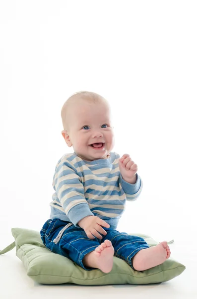 Sweet boy infant smiling sit on green pillow isolated on white b — Stock Photo, Image