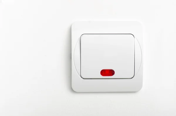 Interruptor de luz com led vermelho na parede branca — Fotografia de Stock
