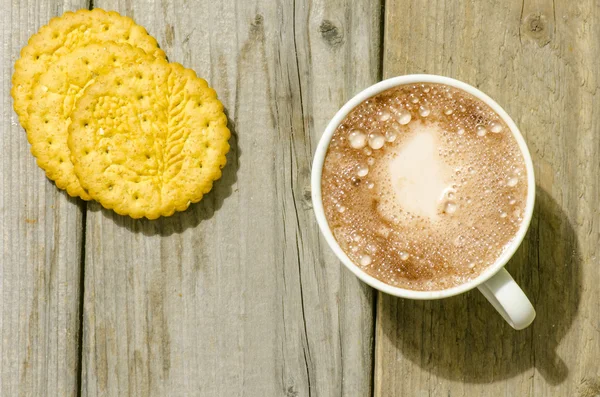 Hot chocolate in white mug and biscuits on wood — Stock Photo, Image