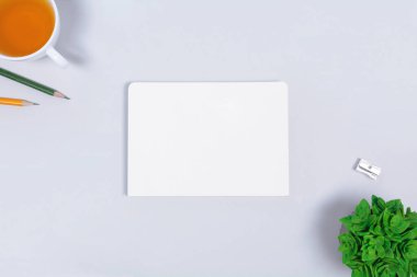 Açık gri arka planda not defteri olan işyeri