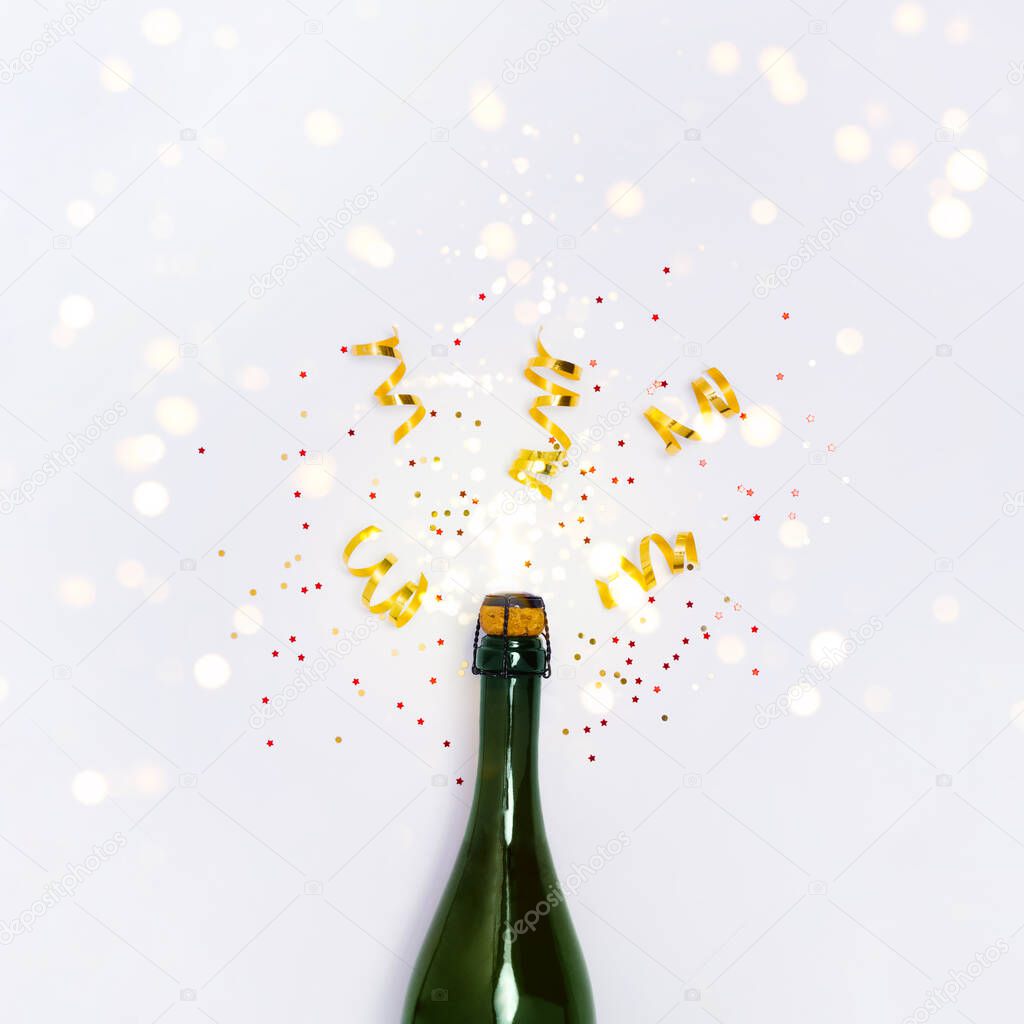 Champagne bottle with lights on white background