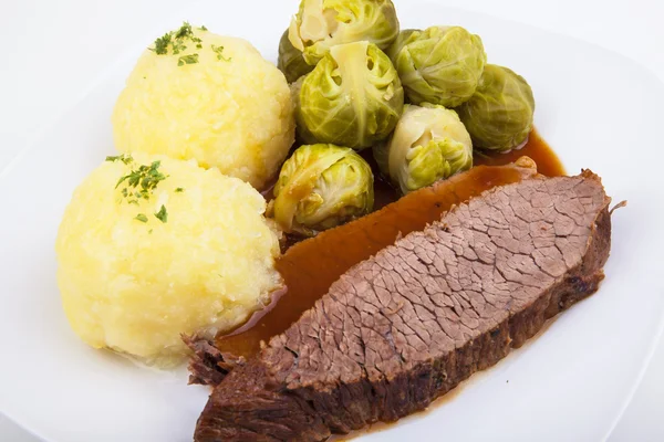 Sauerbraten with Klößen and Brussels sprout — Stockfoto