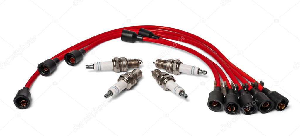 Four spark plugs and red wires of a high pressure are isolated on white background