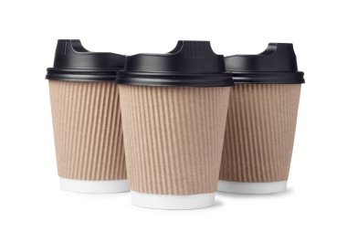 Disposable paper coffee cups with black caps isolated on white background.