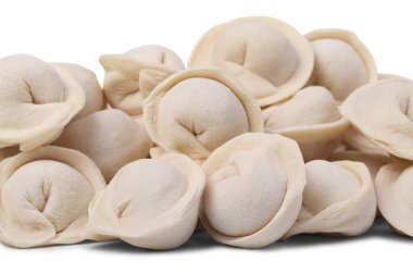 Pile of raw ravioli (or dumplings) isolated on white background. Small depth of focus.