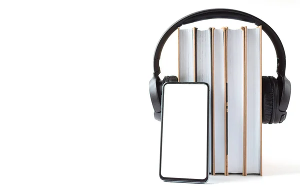 Headphones, phone and books on a white background. Audiobook concept — Stock Photo, Image