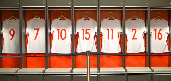 T-shirts hang in the locker room for athletes football players