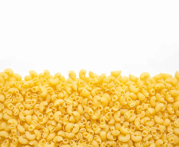 a lot of pasta in the shape of a snail lies on a white background.