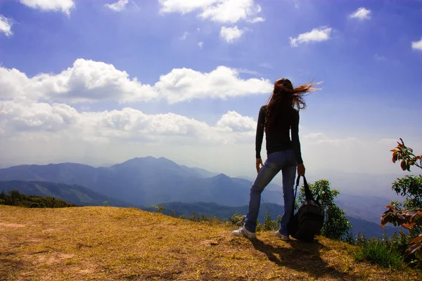 Woman Traveler with Backpack looking at mountain landscape and sky — Stock Photo, Image