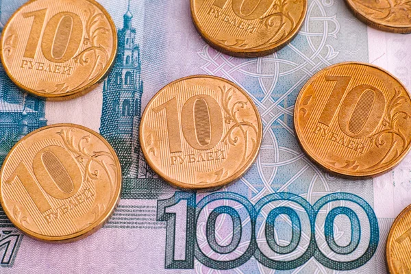 Ruble coins on one thousand rubles banknote — Stock Photo, Image