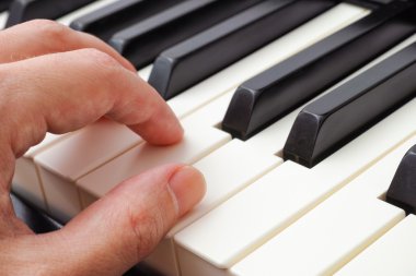 Man hands playing piano