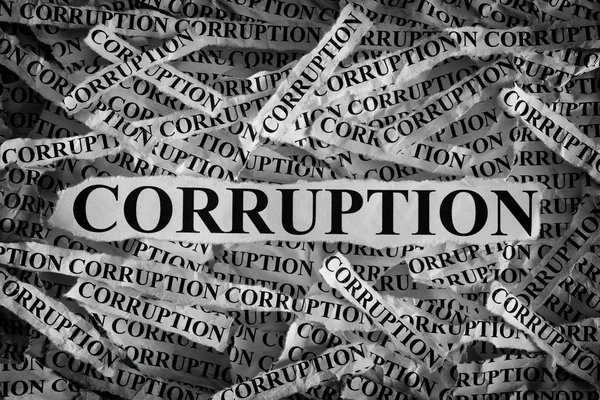 Torn pieces of paper with the word Corruption — Stock Photo, Image