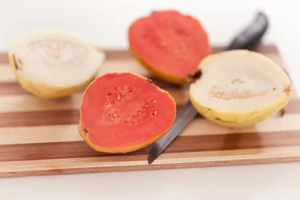 Frutas de goiaba branca e vermelha na tábua de corte — Fotografia de Stock