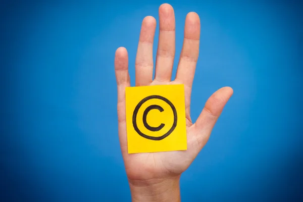 Copyright symbol in woman's palm — Stock Photo, Image