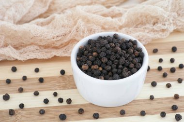 Tüm organik siyah biberler beyaz kasede. Kapat.. 