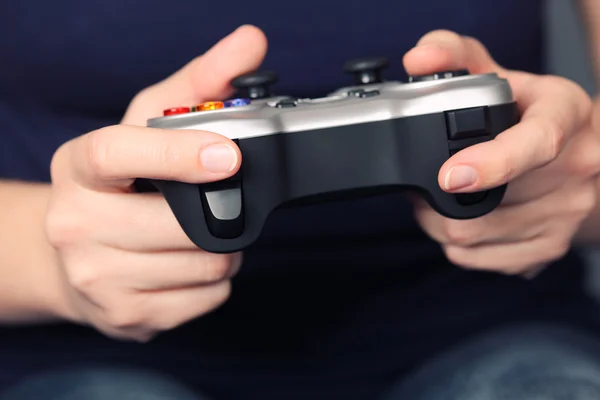 Young woman plays video game using a gamepad — Stock Photo, Image