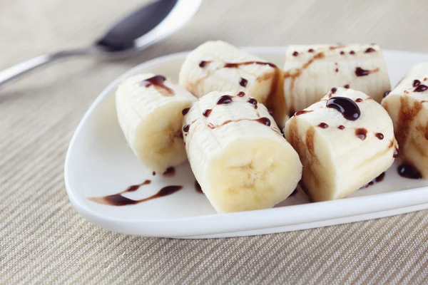 Chopped bananas chocolate sauce — Stock Photo, Image