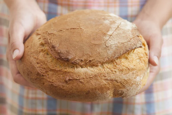 Loaf of bread in woman's hands — Stock Photo, Image