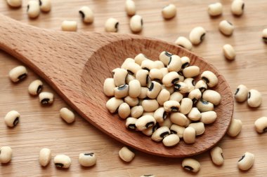 Black eyed peas in a wooden spoon
