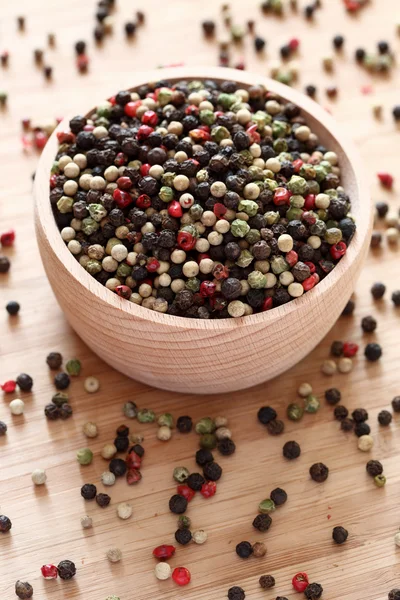 Mixed peppercorns in a wooden bowl — Stock Photo, Image